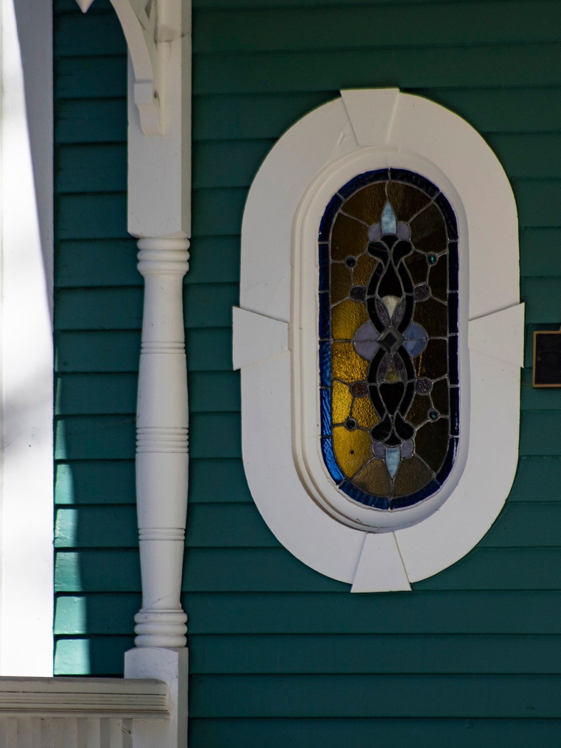 Oval window and porch post on the facade of the M.A. Hale Residence, Atlanta