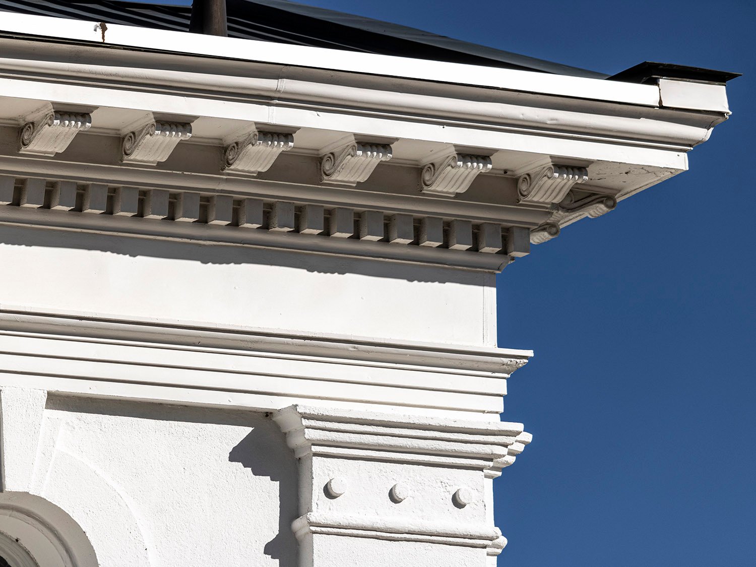 Eaves, cornice, and pilaster capital on the facade of First Methodist Church, Opelika, Alabama