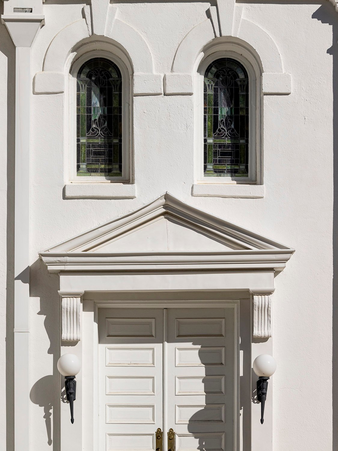 Door and second-floor windows on the facade of First Methodist Church, Opelika, Alabama