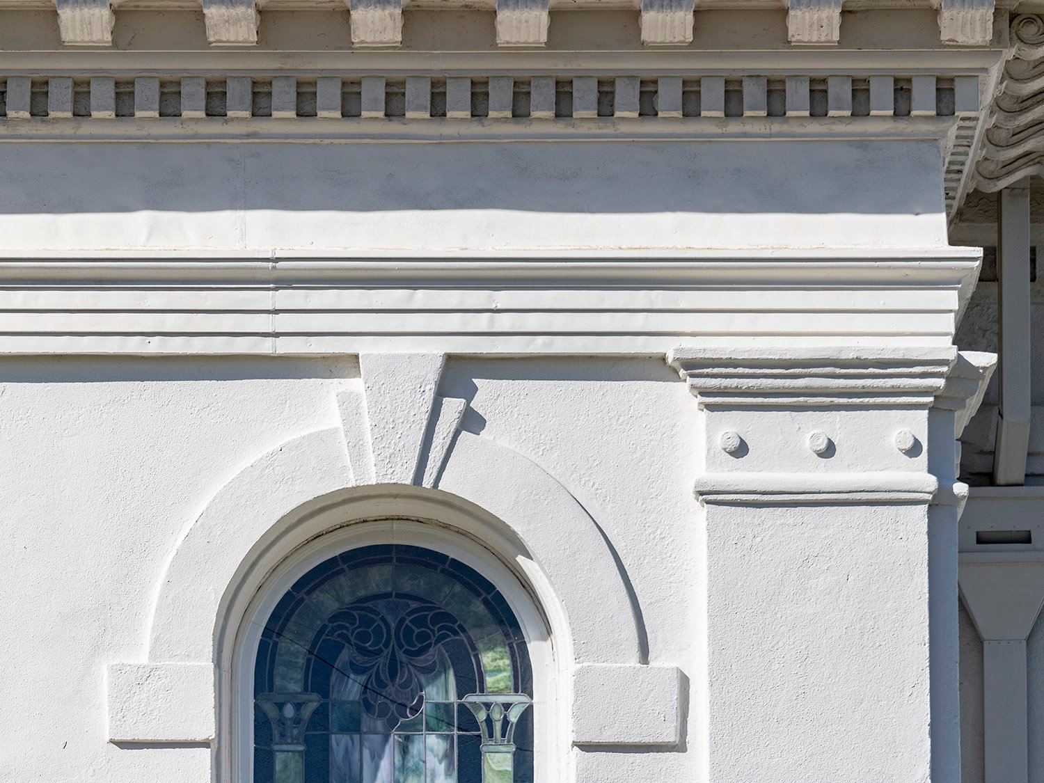 Second-floor window, cornice, and pilaster on the southeast corner of First Methodist Church, Opelika, Alabama