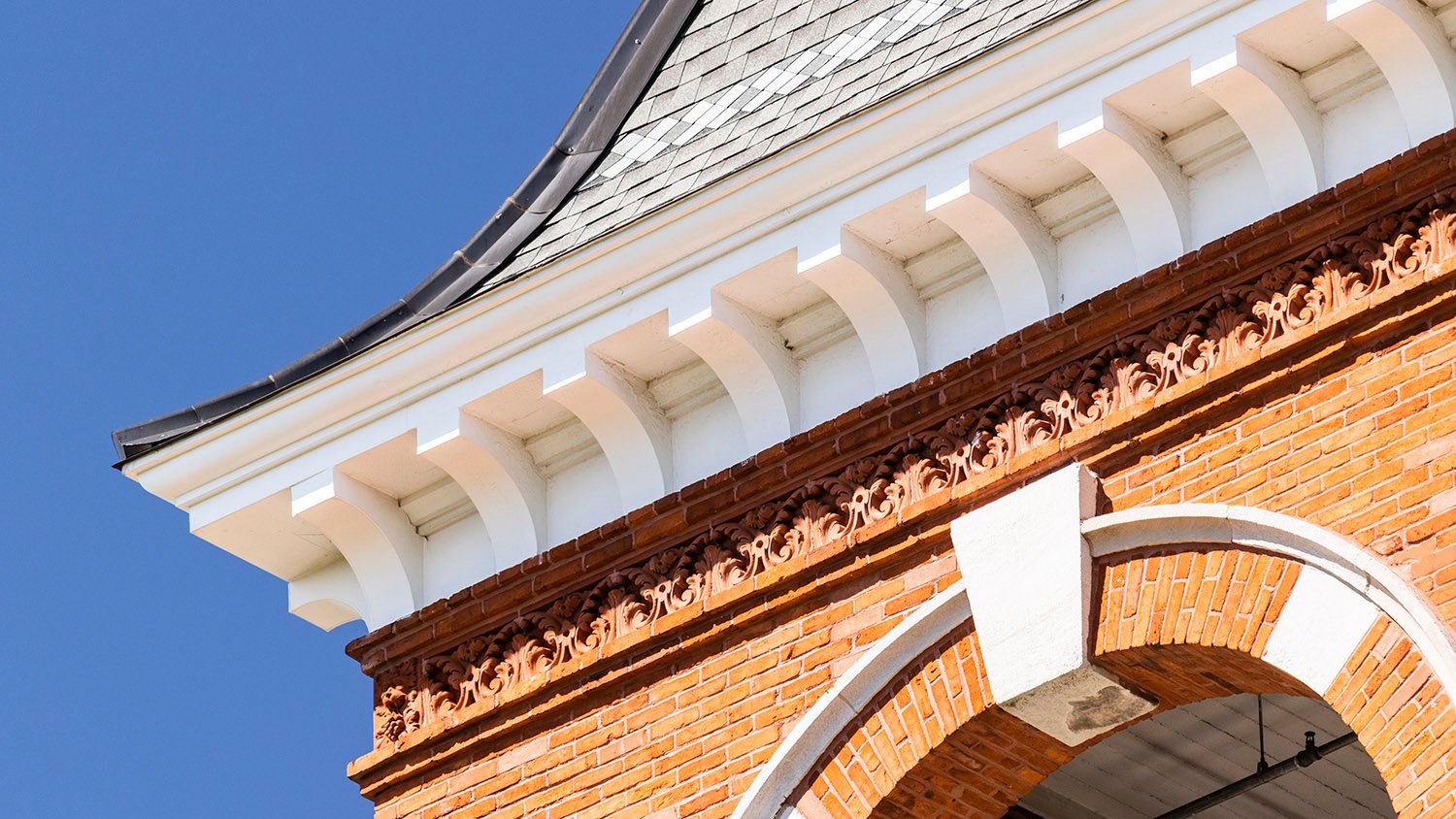 Eaves, brackets, and terracotta frieze on a tower of Samford Hall, Auburn, Alabama