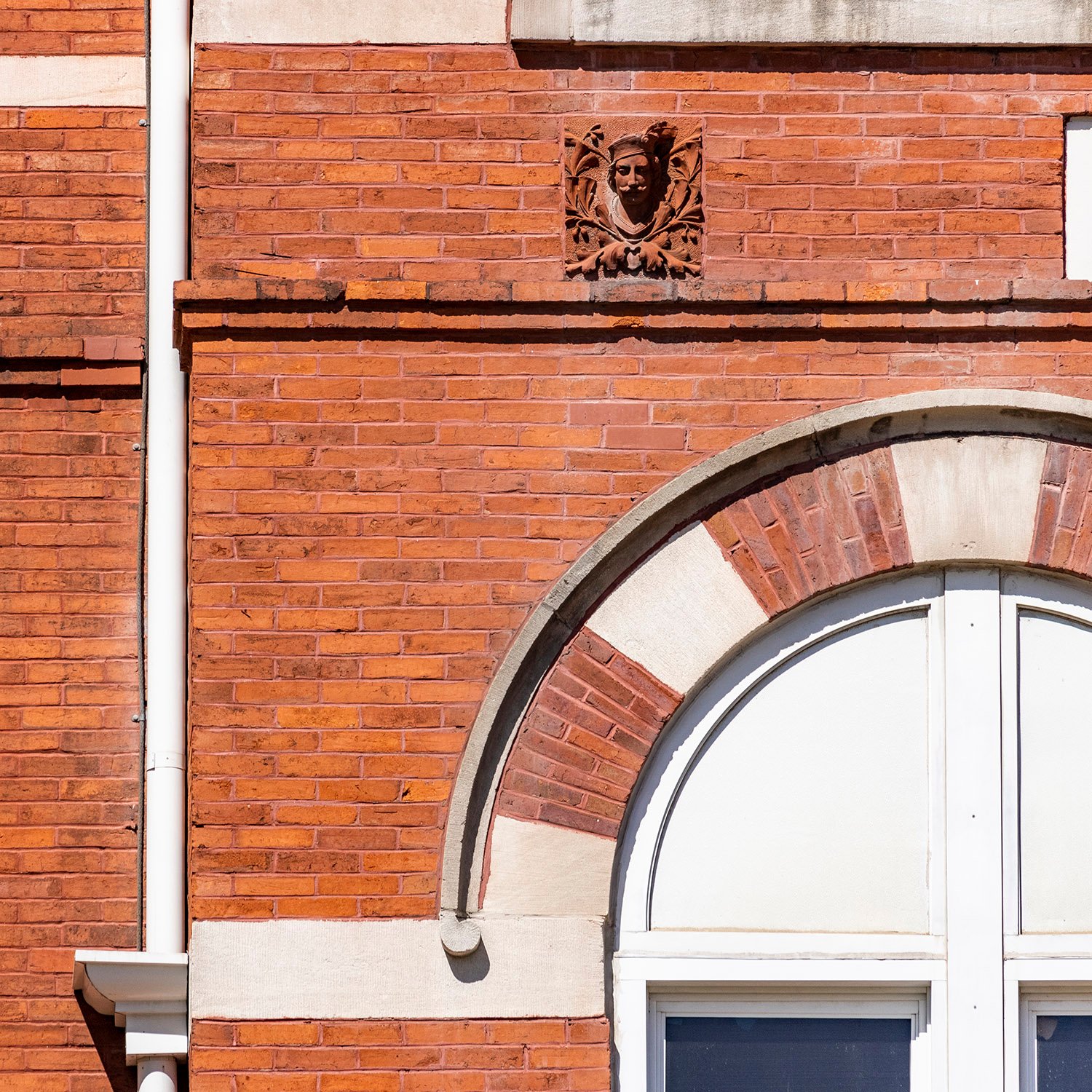 Terracotta ornamental figure and a second-floor window on the facade of Samford Hall, Auburn, Alabama