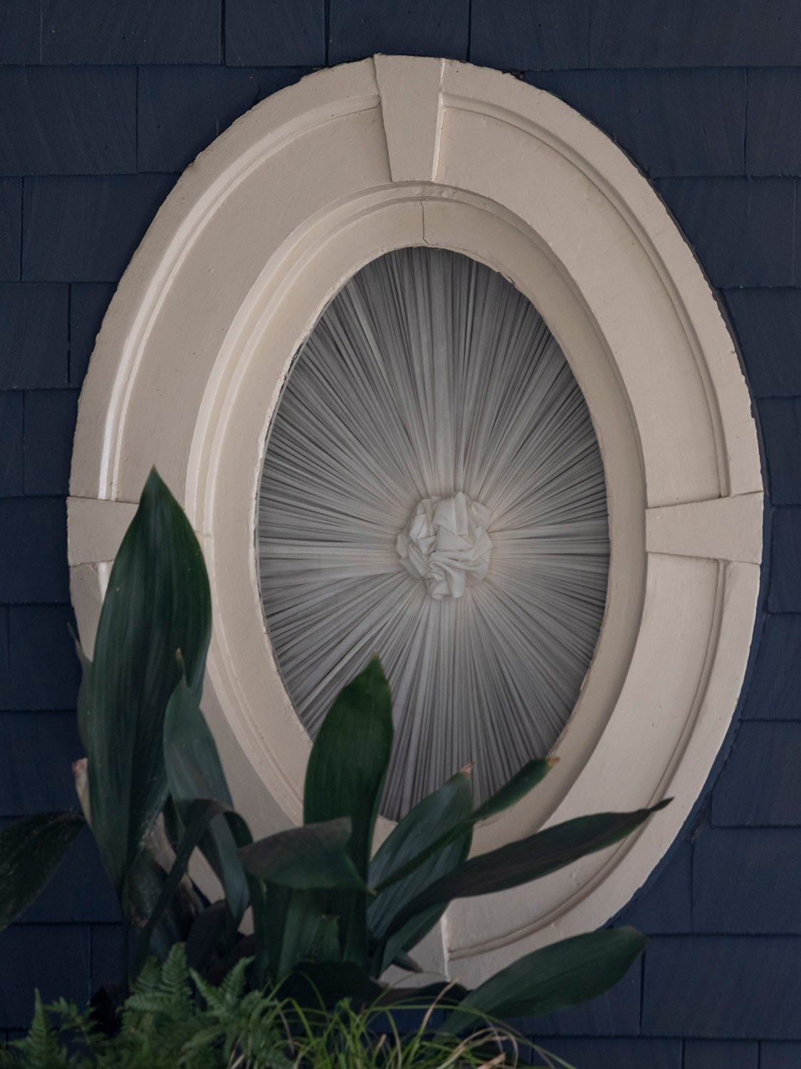 Oval window on the east facade of the C.D. Hurt Residence
