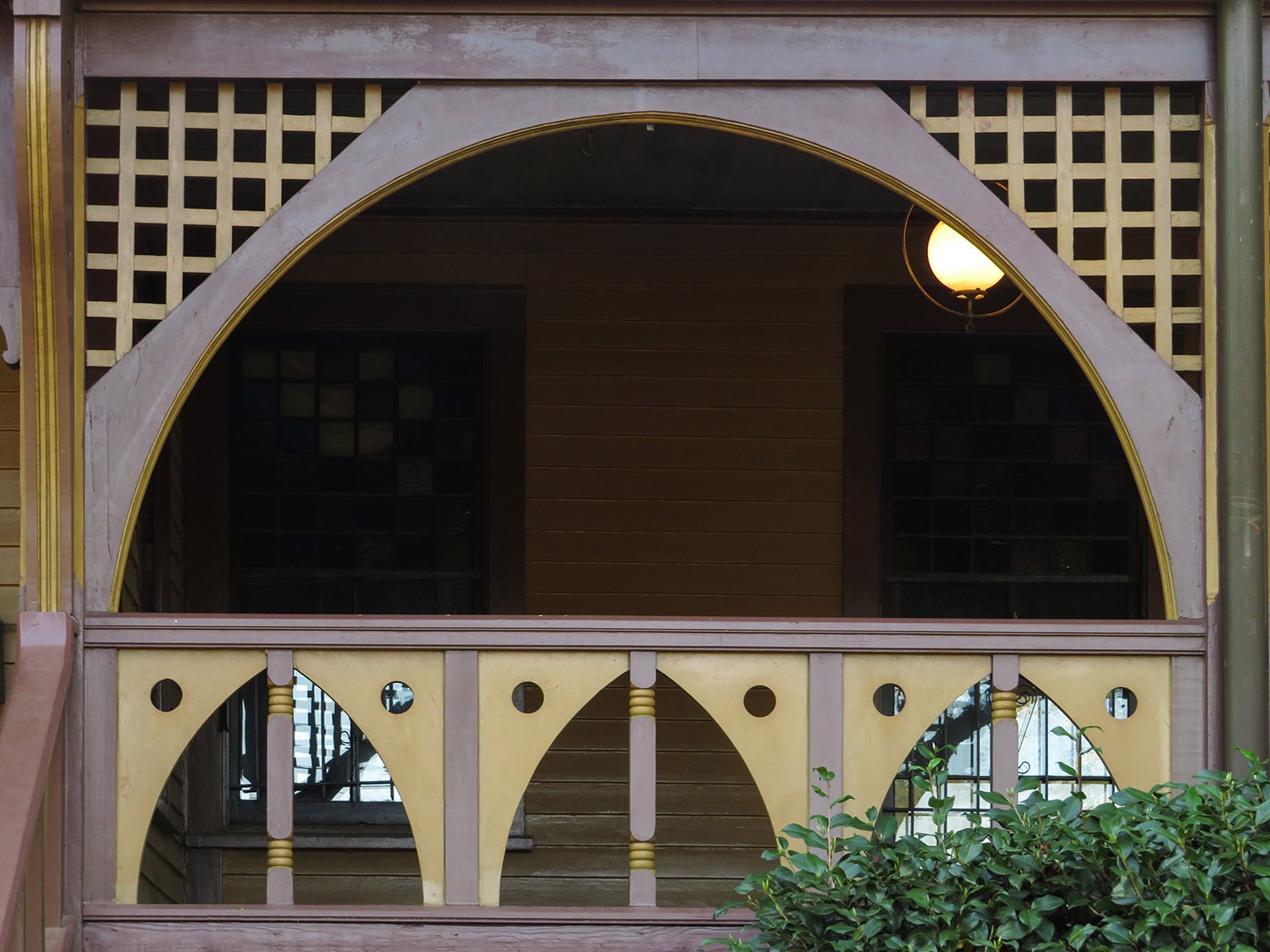 Fretwork rails and latticework on the front porch of The Wren's Nest
