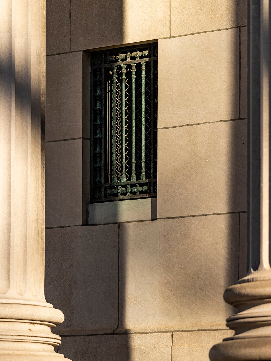 Looking between columns at a window on the facade of the Cooper Branch Free Public Library, Camden, New Jersey