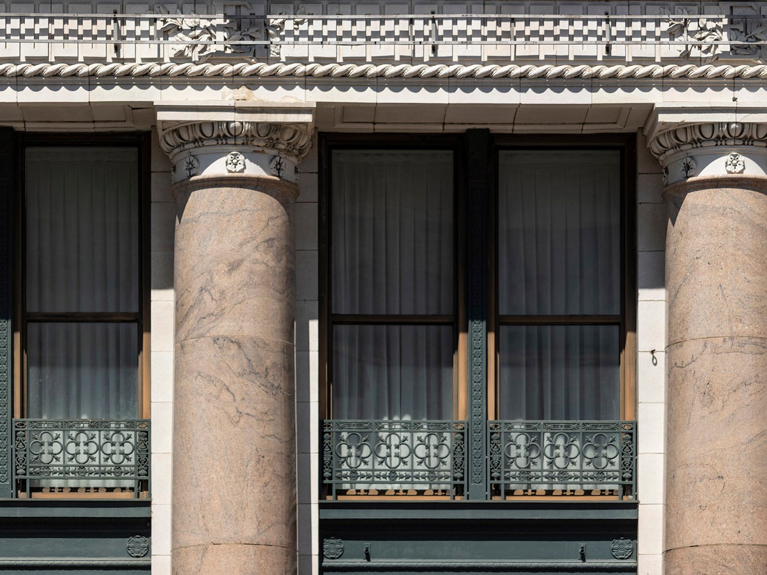 Frieze, columns, and second-floor windows on the facade of the Empire Building, Birmingham, Alabama