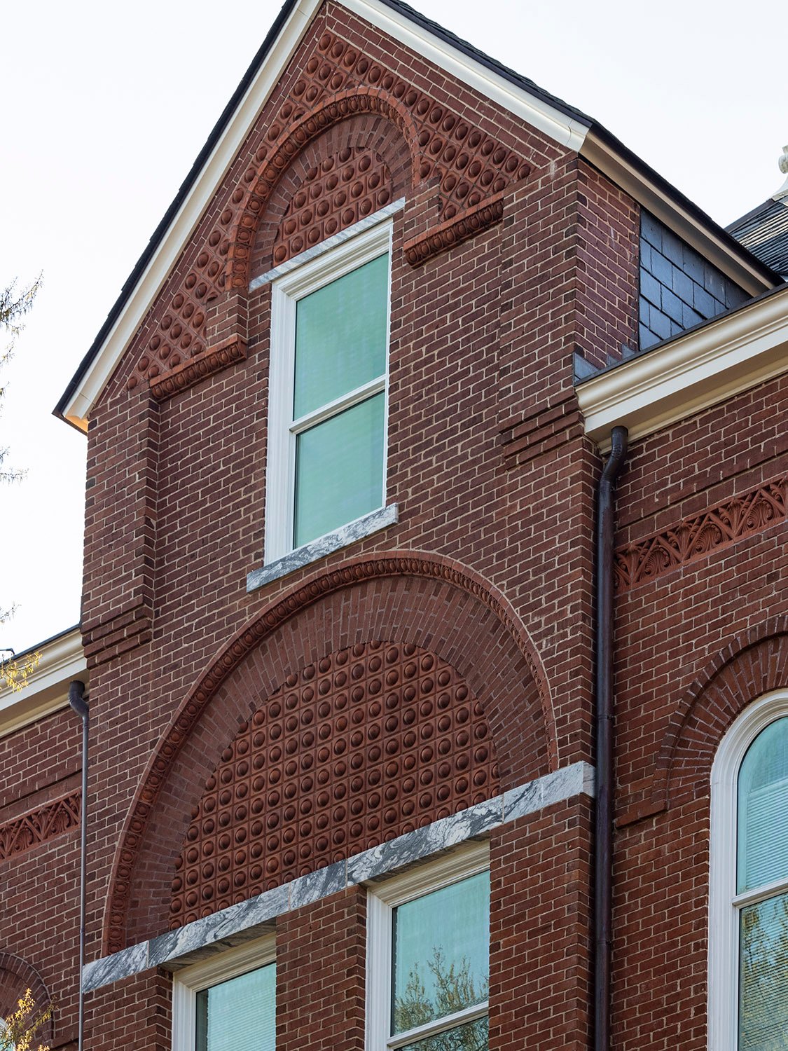Dormered gable and blind arches with terracotta ornamentation on the facade of Agnes Scot Hall, Decatur, Georgia