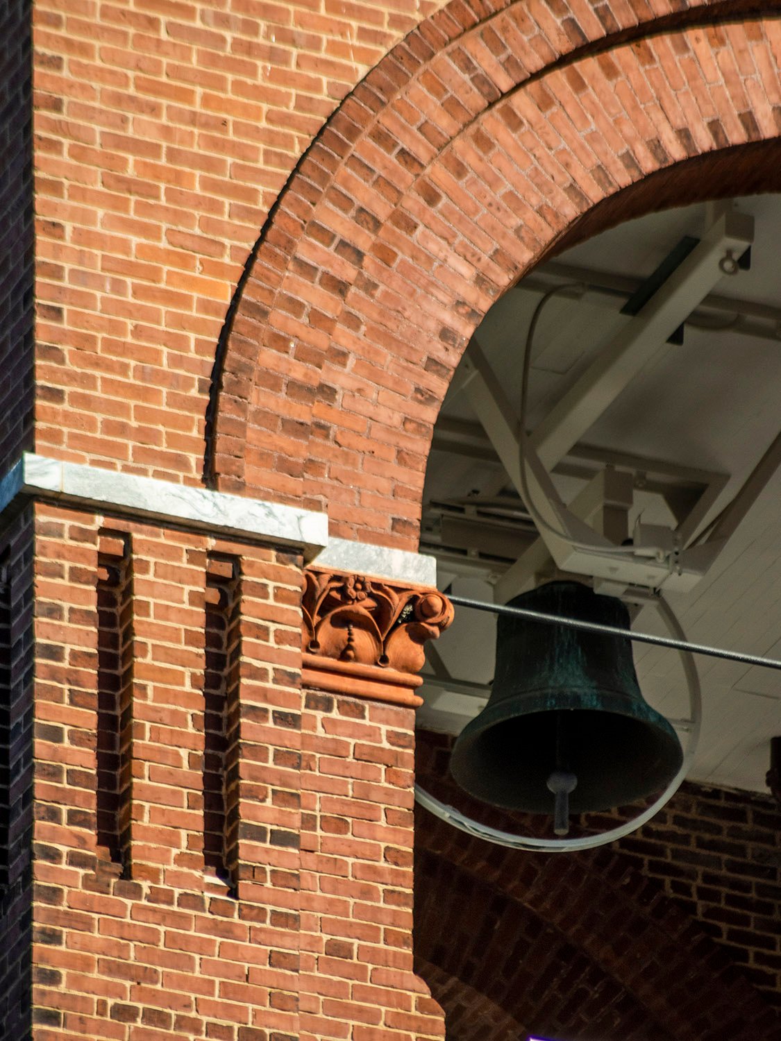 Arch, terracotta ornamentation, and bell on the tower of Agnes Scott Hall, Decatur, Georgia