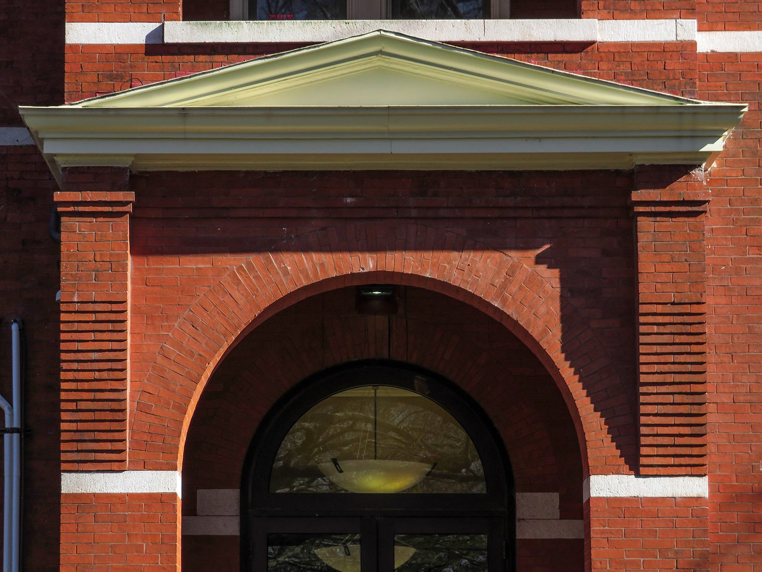 Roman arch, corbels, and pediment on the west entrance of the Academic Building at Georgia Tech, Atlanta