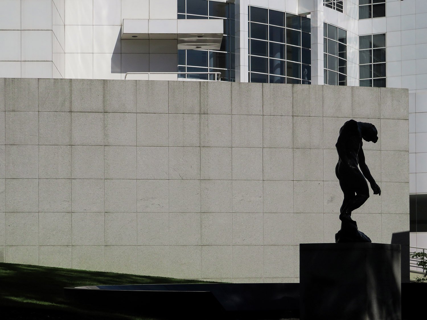 Looking at the High Museum of Art from the southeast. In foreground: Auguste Rodin. The Shade (1880).