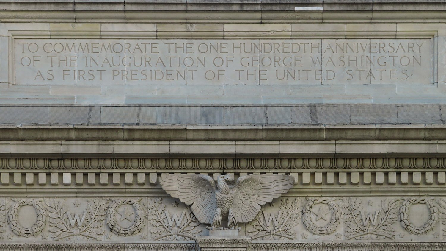 Inscription, cornice and frieze on the north facade of the Washington Square Arch, New York
