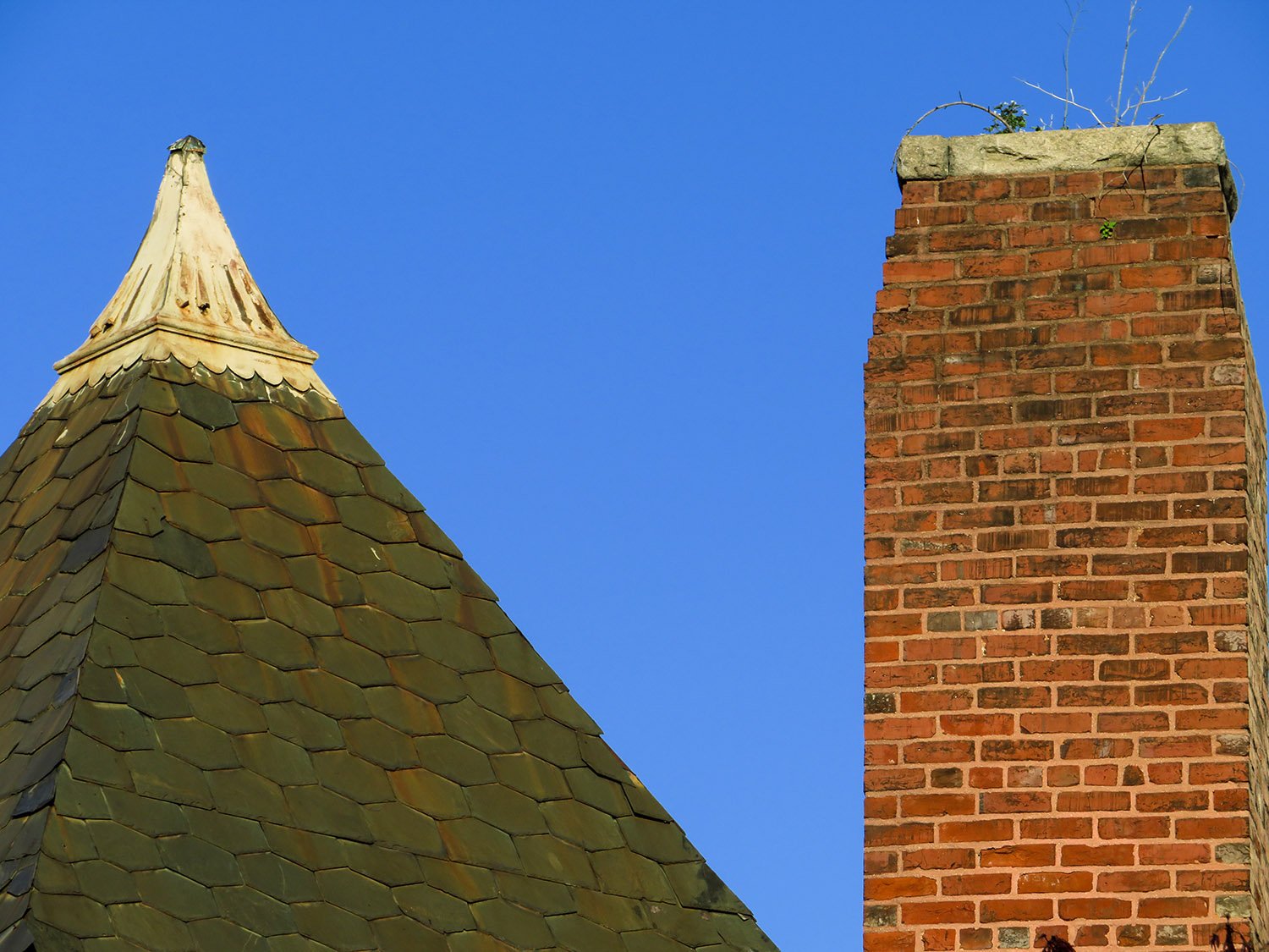Turret finial and tapered chimney on the west elevation of 125 Edgewood Avenue, Atlanta
