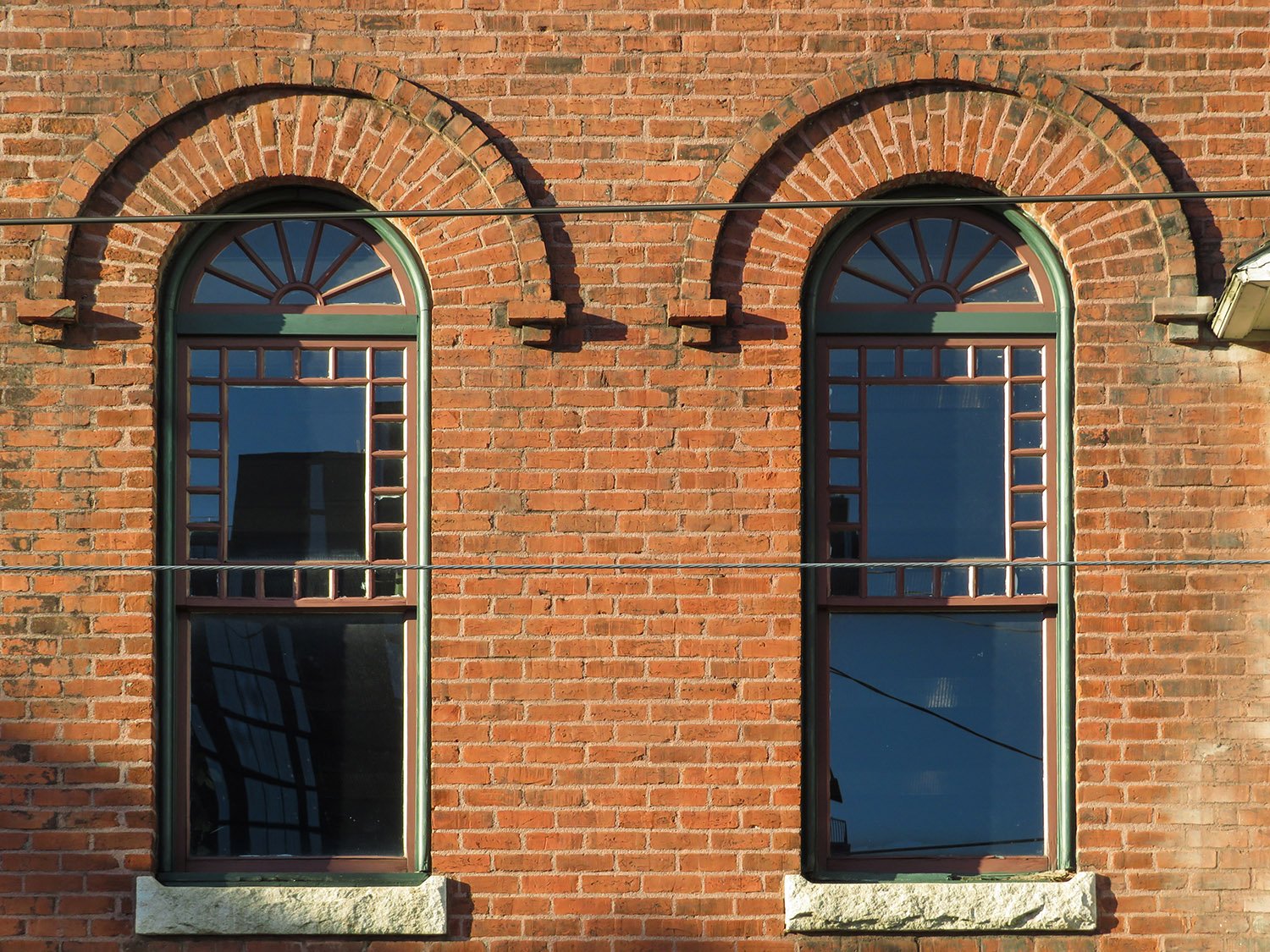 Second-floor arch windows on the facade of 125 Edgewood Avenue, Atlanta