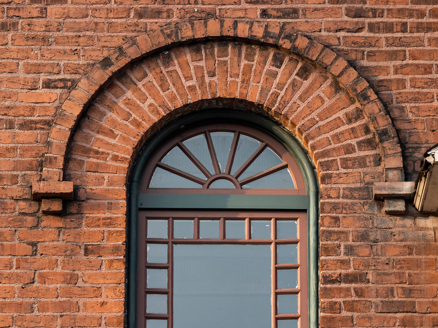 Second-floor arch window and brickwork on the facade of 125 Edgewood Avenue, Atlanta