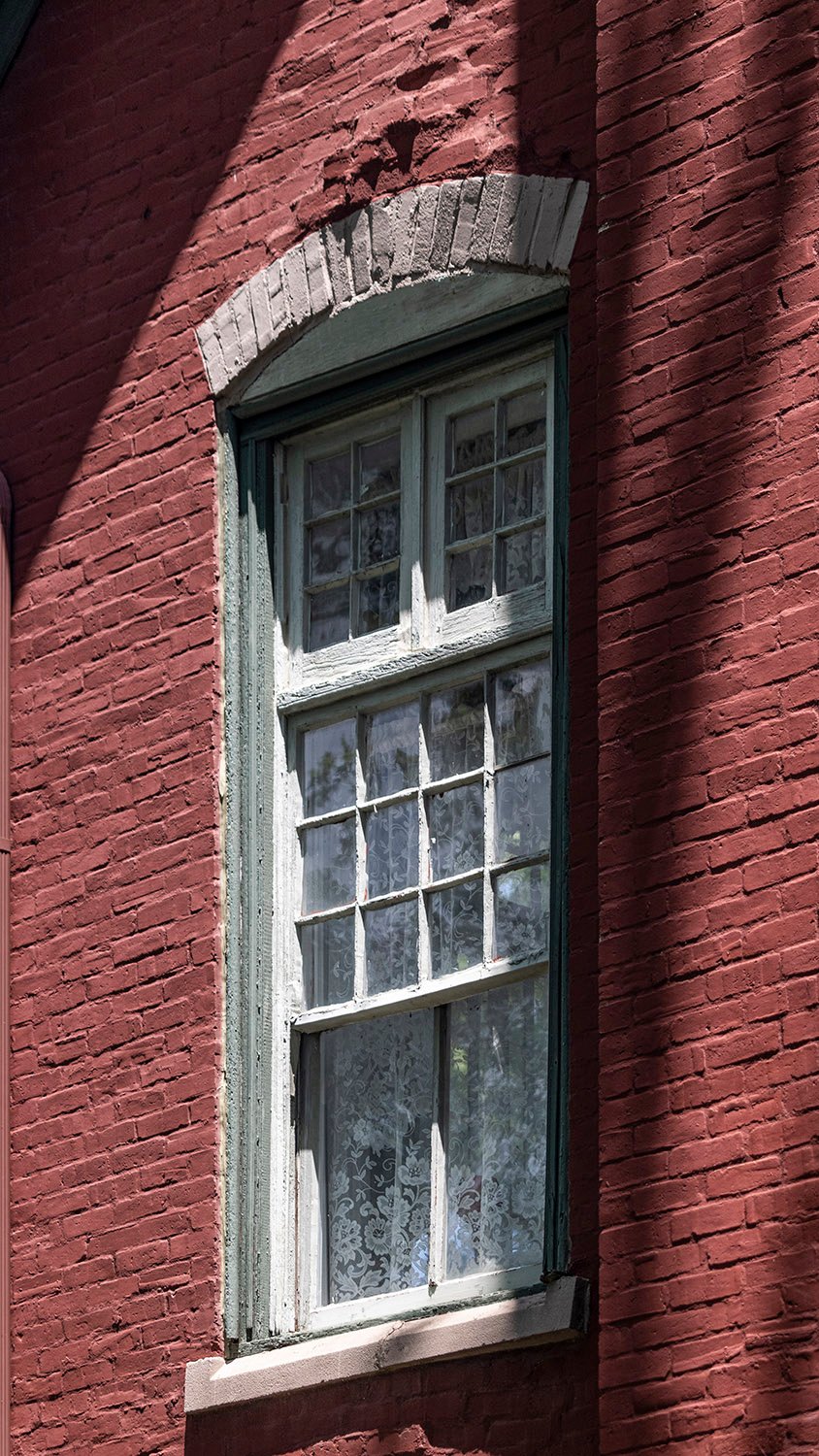 Window on the Anniston Inn kitchen and dining hall