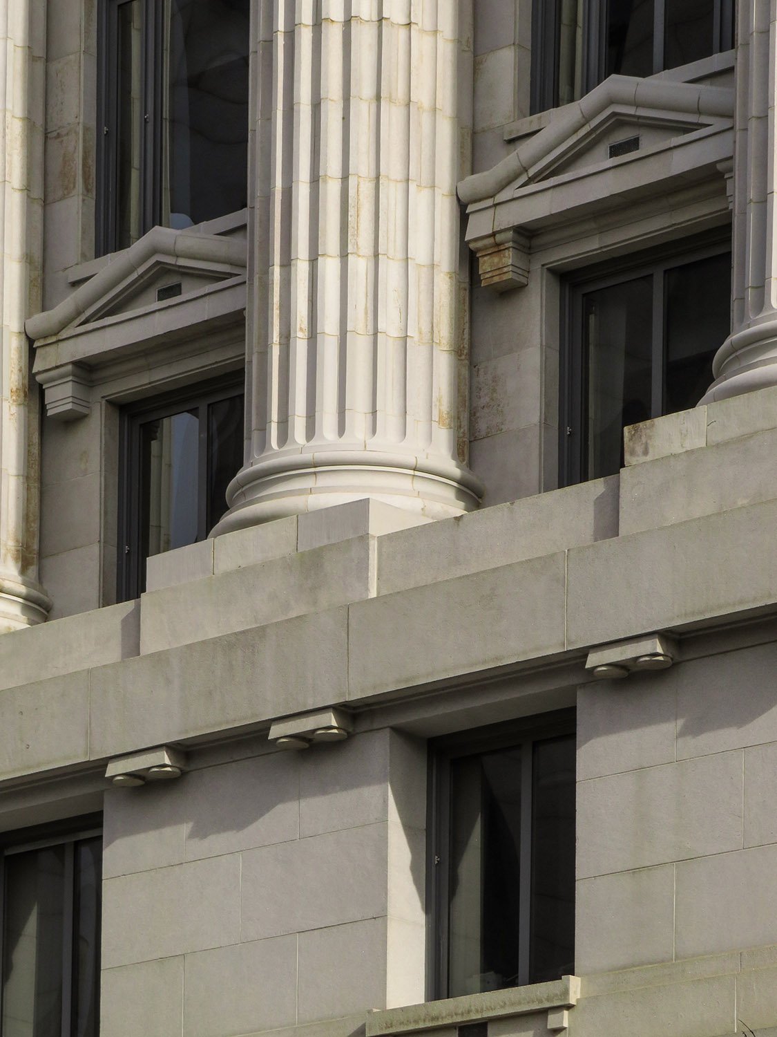 Columns, pedestals, and second- and third-floor windows on the facade of the Fulton County Courthouse, Atlanta