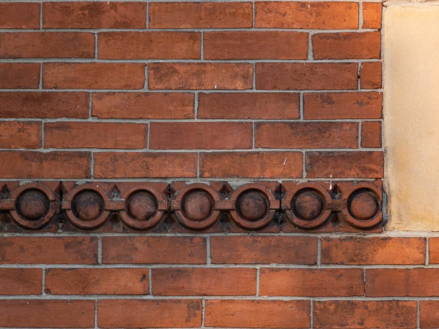 Terracotta stringcourse on the facade of The Priest's House