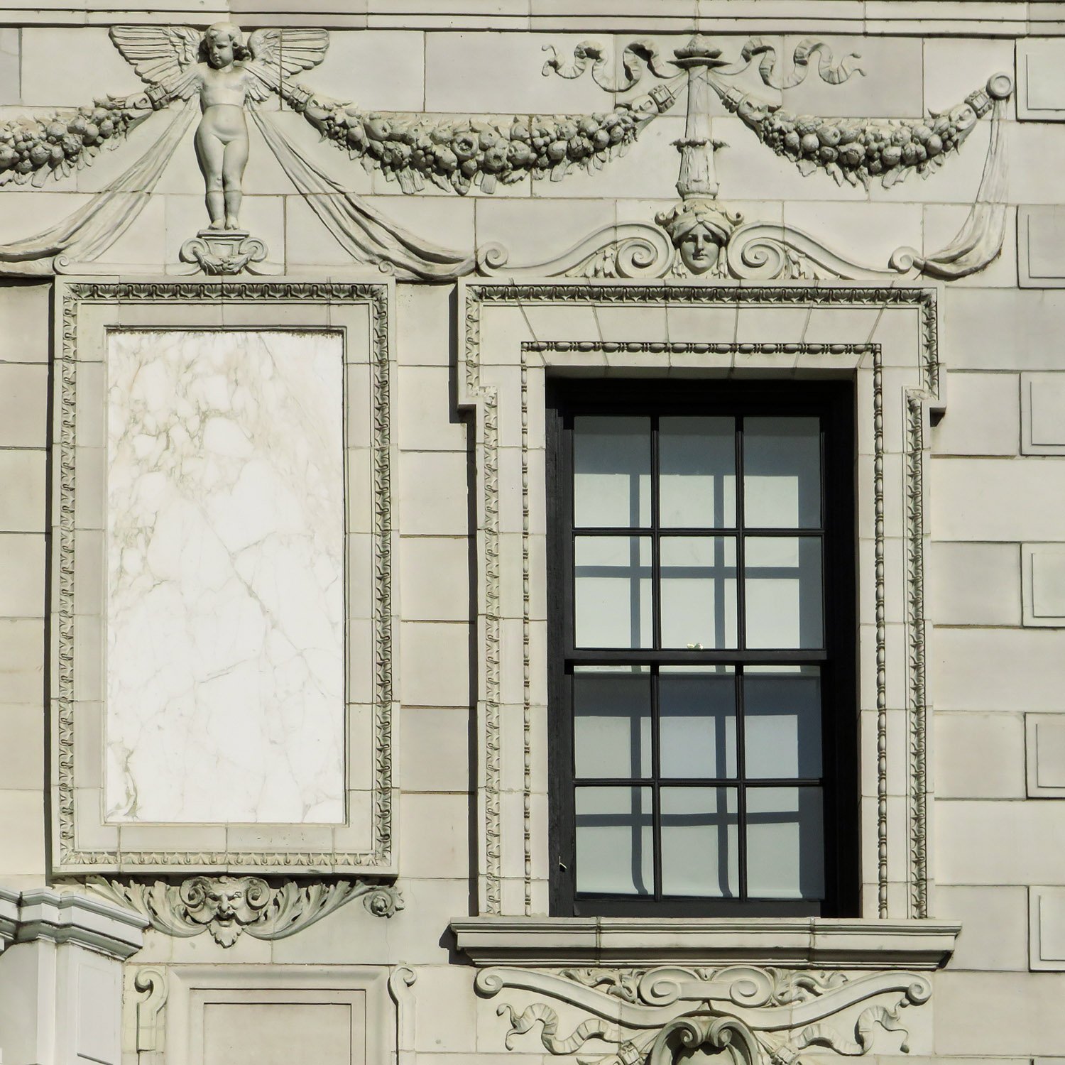 Third-floor window, marble panel, and ornamentation on the facade of the Robert Wilson Patterson Residence, Washington, D.C. 