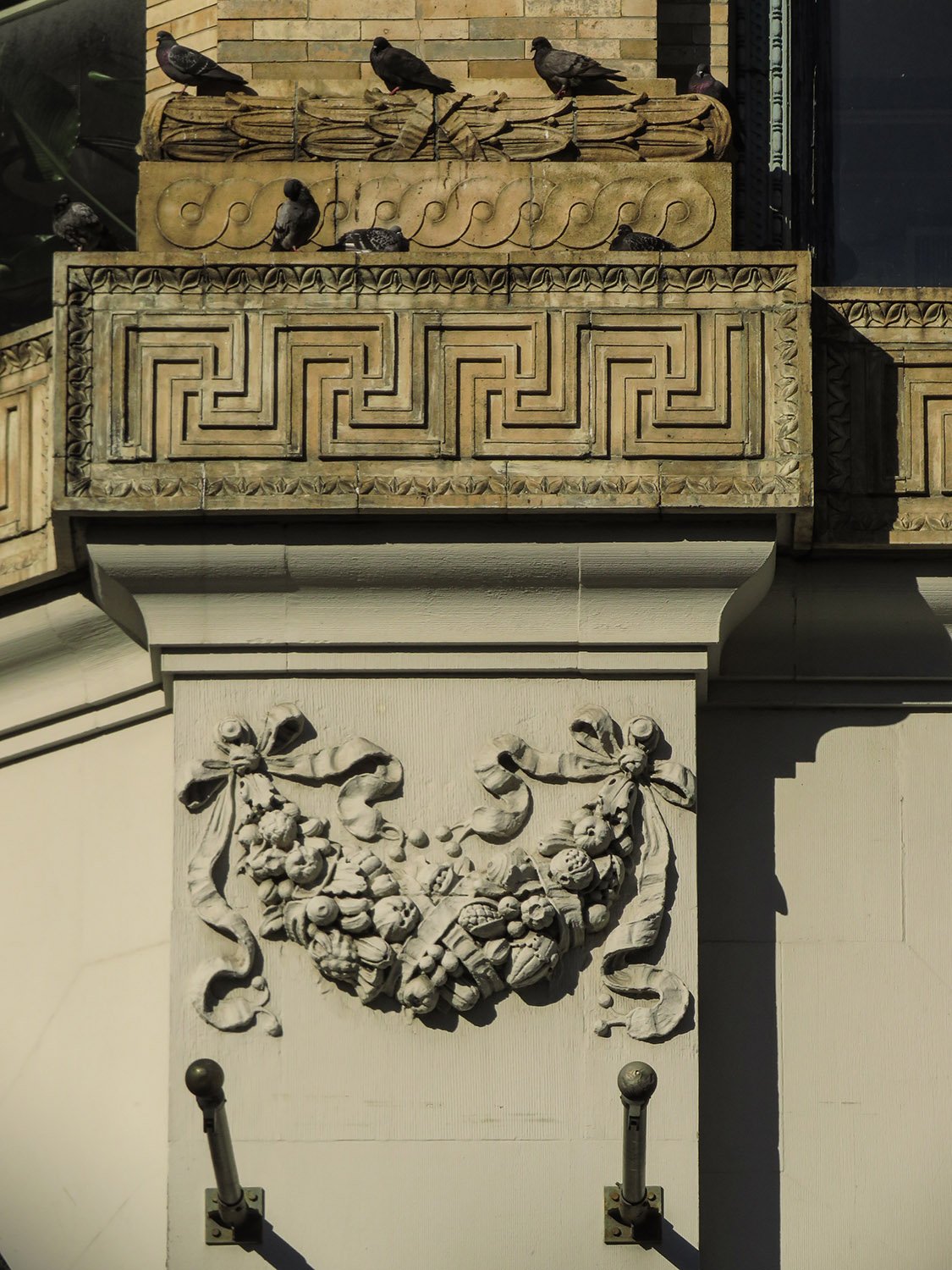 Stringcourse, pilaster, and terracotta ornamentation on the Cable Building, New York