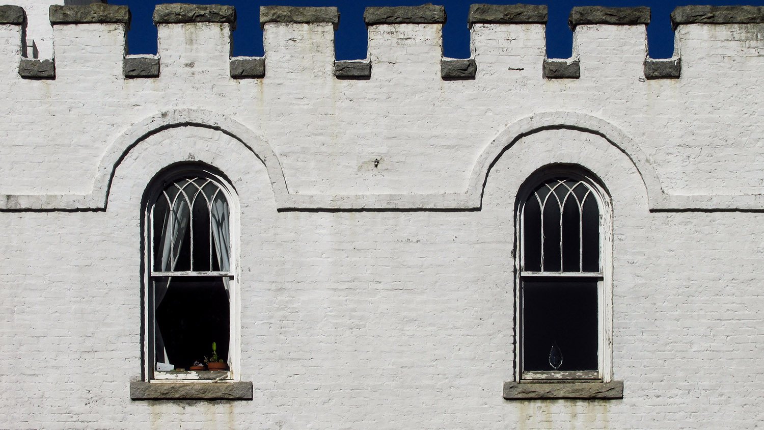 Second-floor windows on the Public Comfort Building