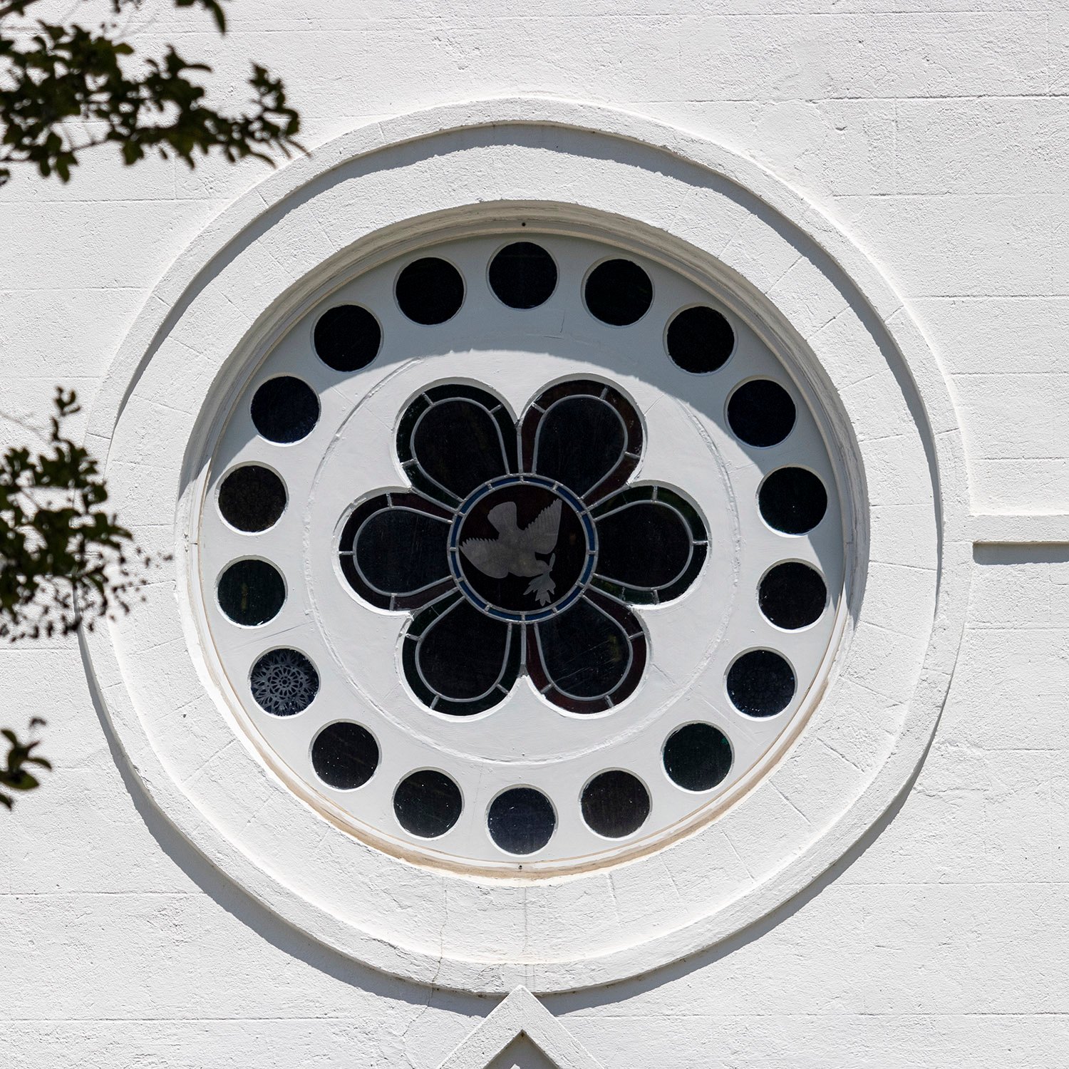 Rose window on the southwest facade of Sacred Heart Catholic Church