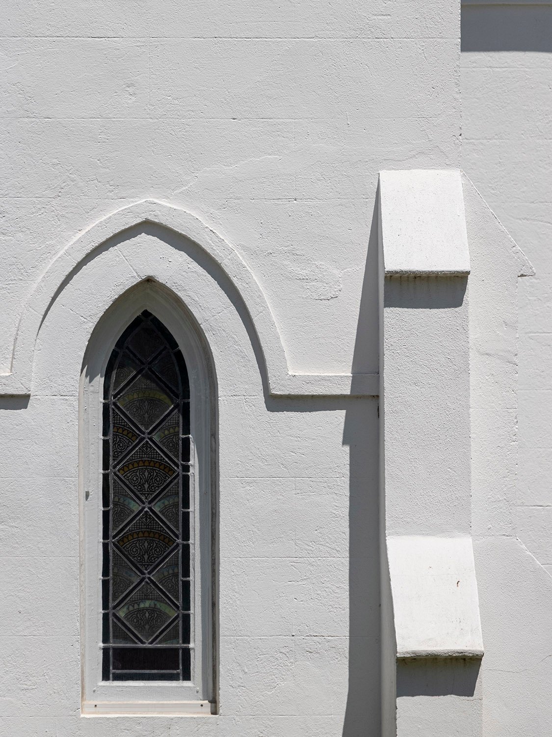 Transept window and buttress on the southeast elevation of Sacred Heart Catholic Church, Abbeville, South Carolina