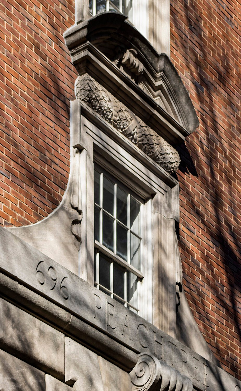 Segmental pediment and ornamentation on second-floor window of 696 Peachtree Apartments