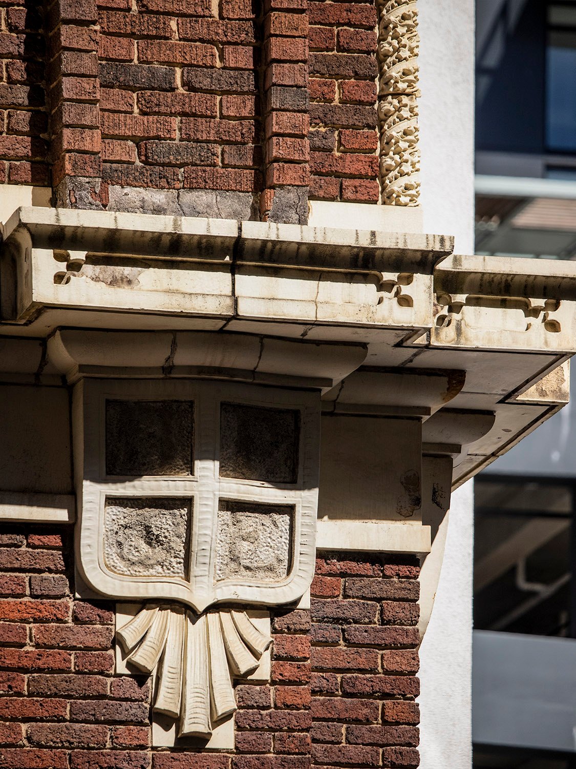 Terracotta console and molding on the facade of Atlanta Lodge
