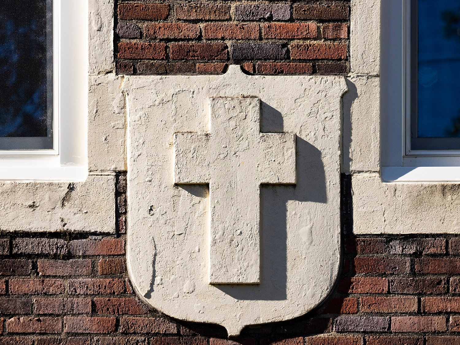 Cross and shield ornament on the Church of the Epiphany Parish House