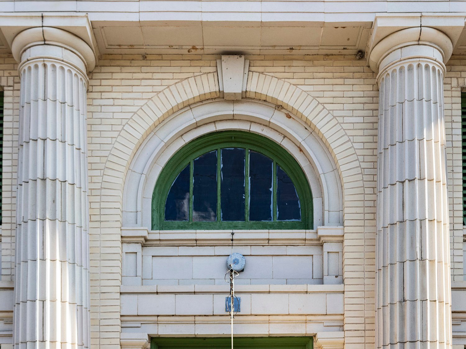 Columns and the second-floor arch window on the facade of First National Bank, Conyers, Georgia