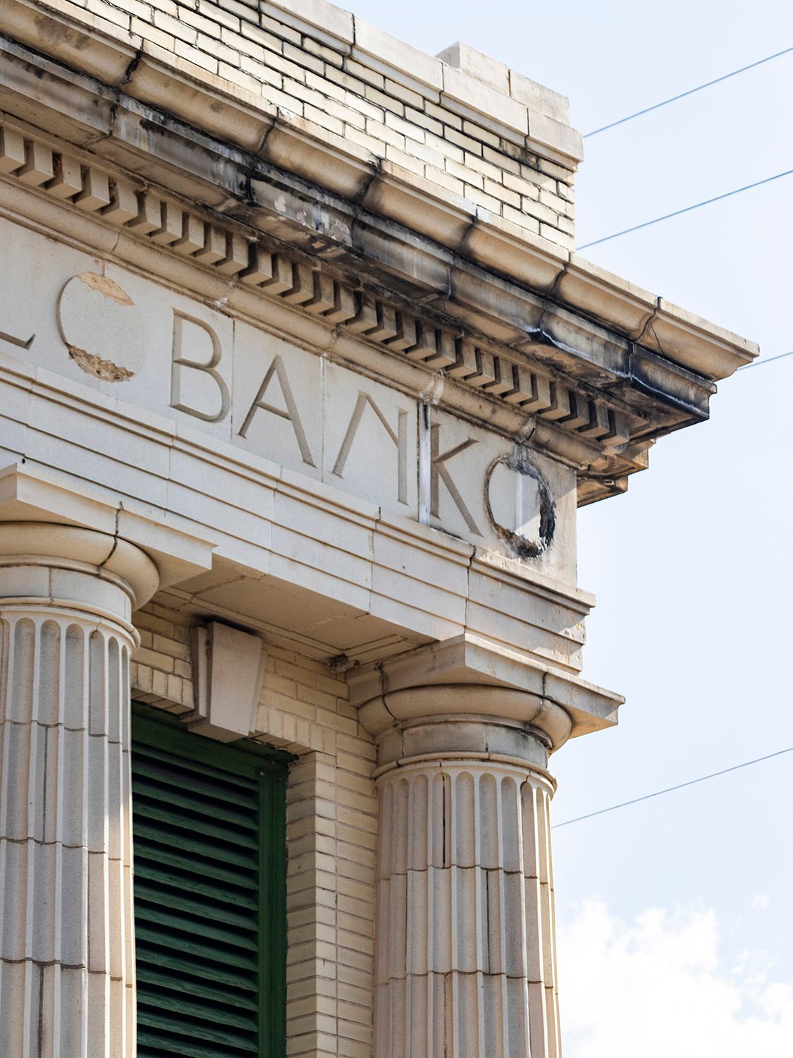 Cornice, inscription, and columns on the facade of First National Bank, Conyers, Georgia
