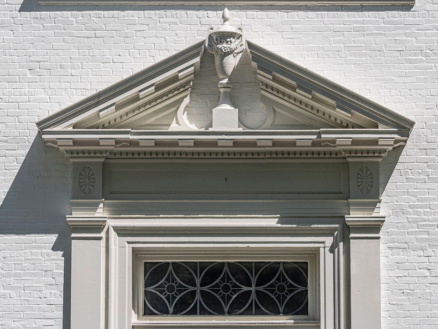 Swan-neck pediment with urn on the facade of the Second Ponce de Leon Baptist Church