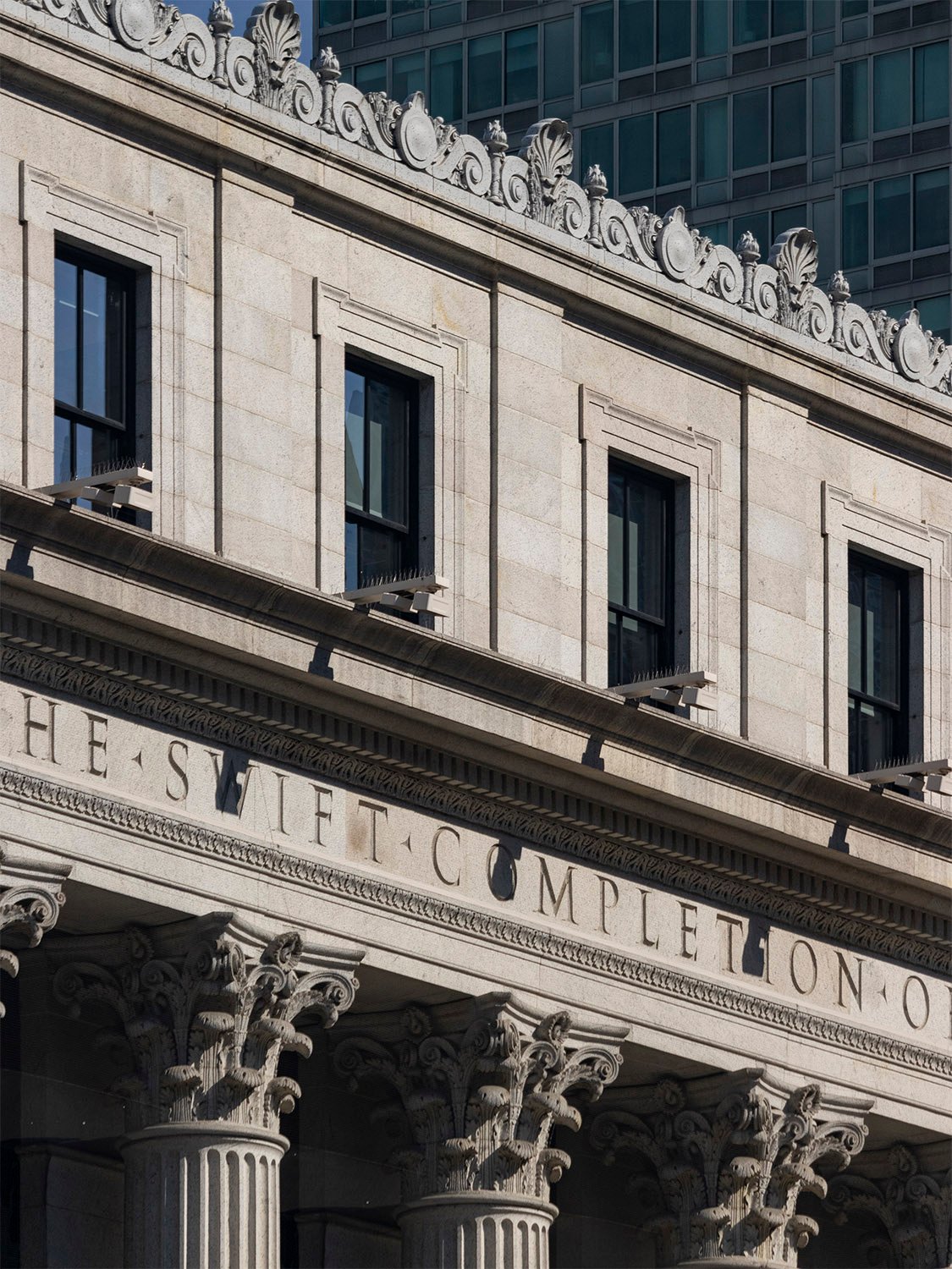 Fourth-floor windows, inscription, and Corinthian capitals on the facade of the United States Post Office, New York