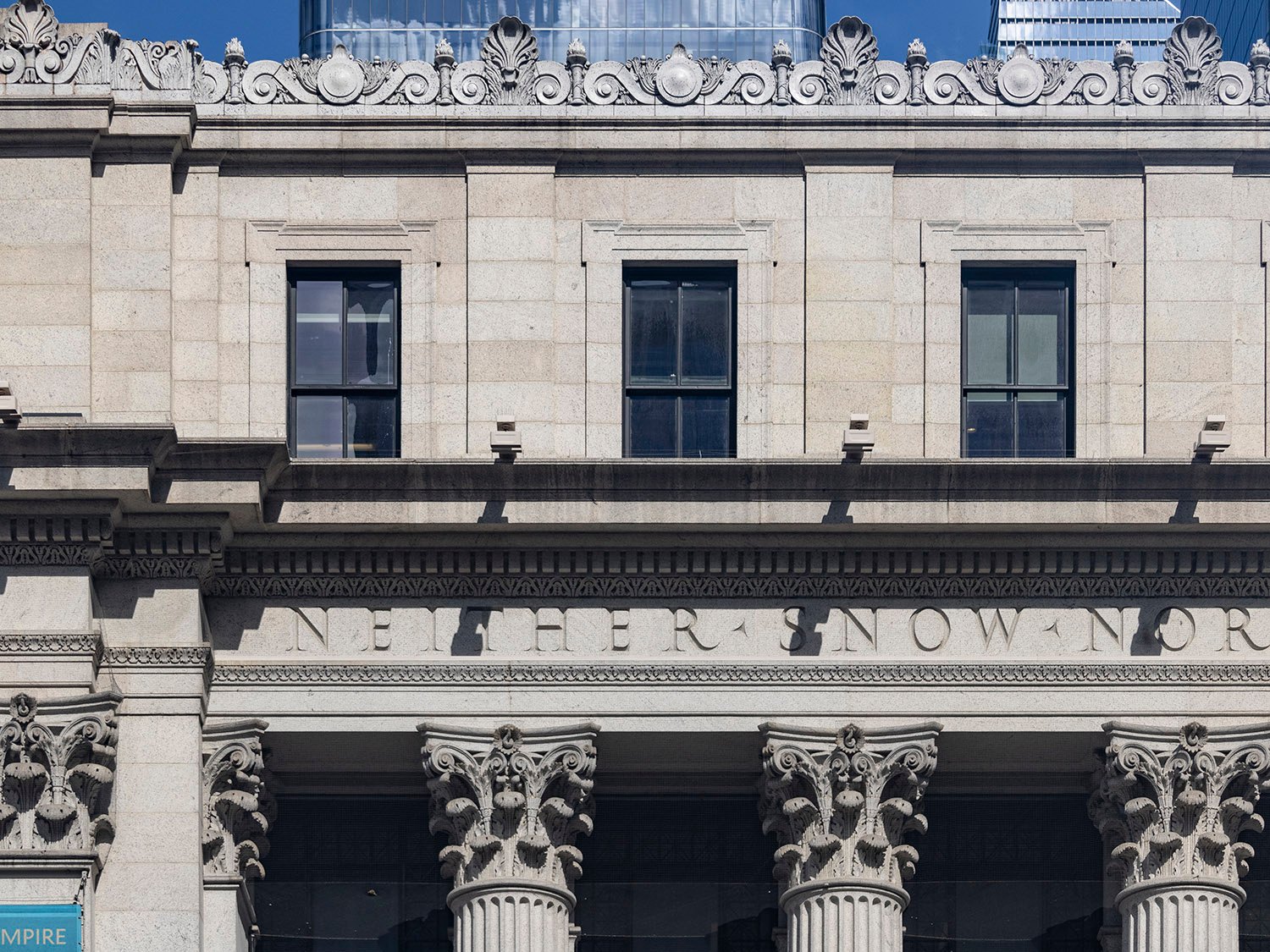 Fourth-floor windows, inscription, and Corinthian capitals on the facade of the United States Post Office, New York