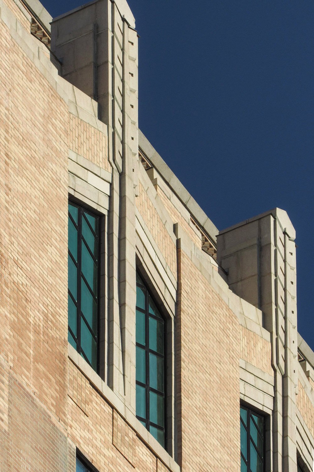 Sixth-floor windows and pinnacles on the facade of the City Building, Asheville, North Carolina