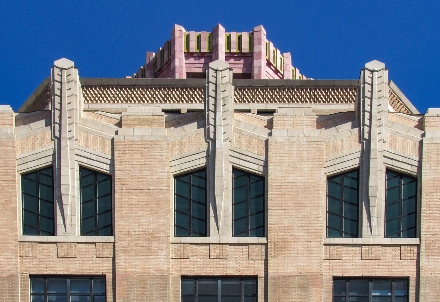 Sixth-floor windows, pinnacles, and cornice on the facade of the City Building, Asheville, North Carolina