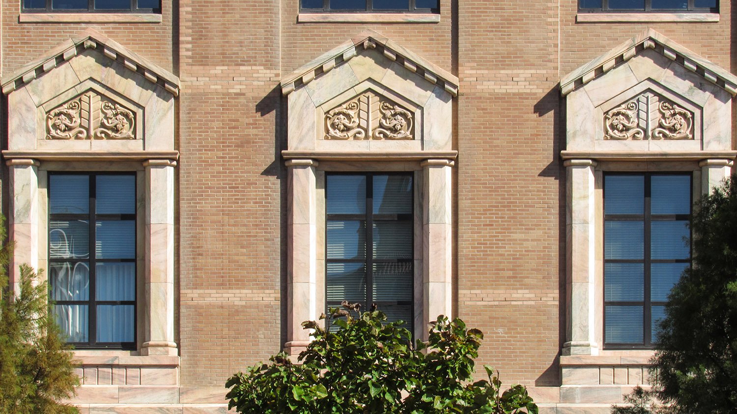 Second-floor windows on the facade of the City Building, Asheville, North Carolina