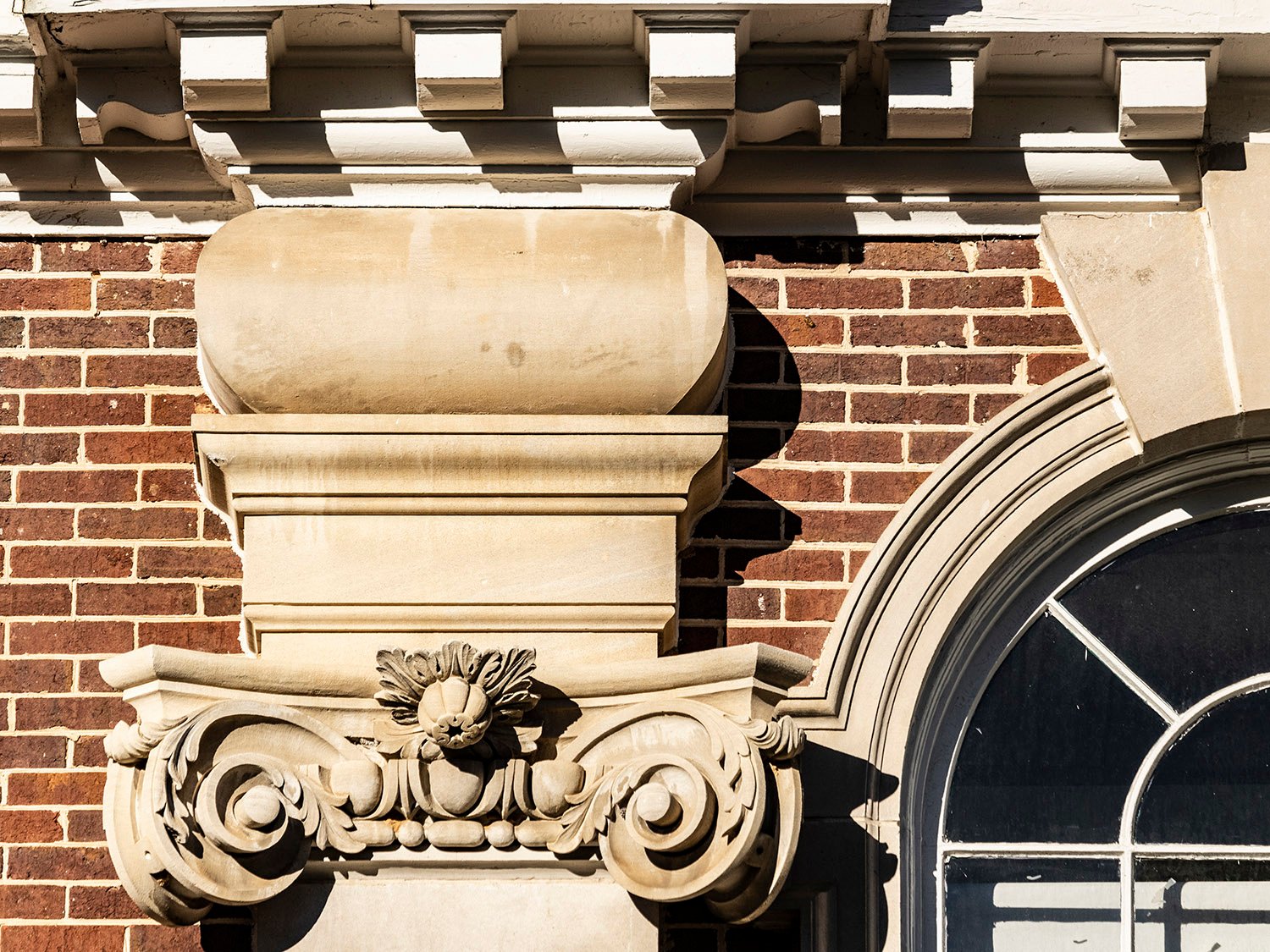 Dentilled cornice, cushion capital, Scamozzi capital, and arch window on the facade of North Fulton High School, Atlanta