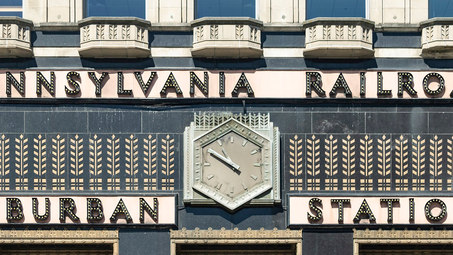 Station sign, clock, and inscribed wheat sheaves on the facade of Suburban Station, Philadelphia