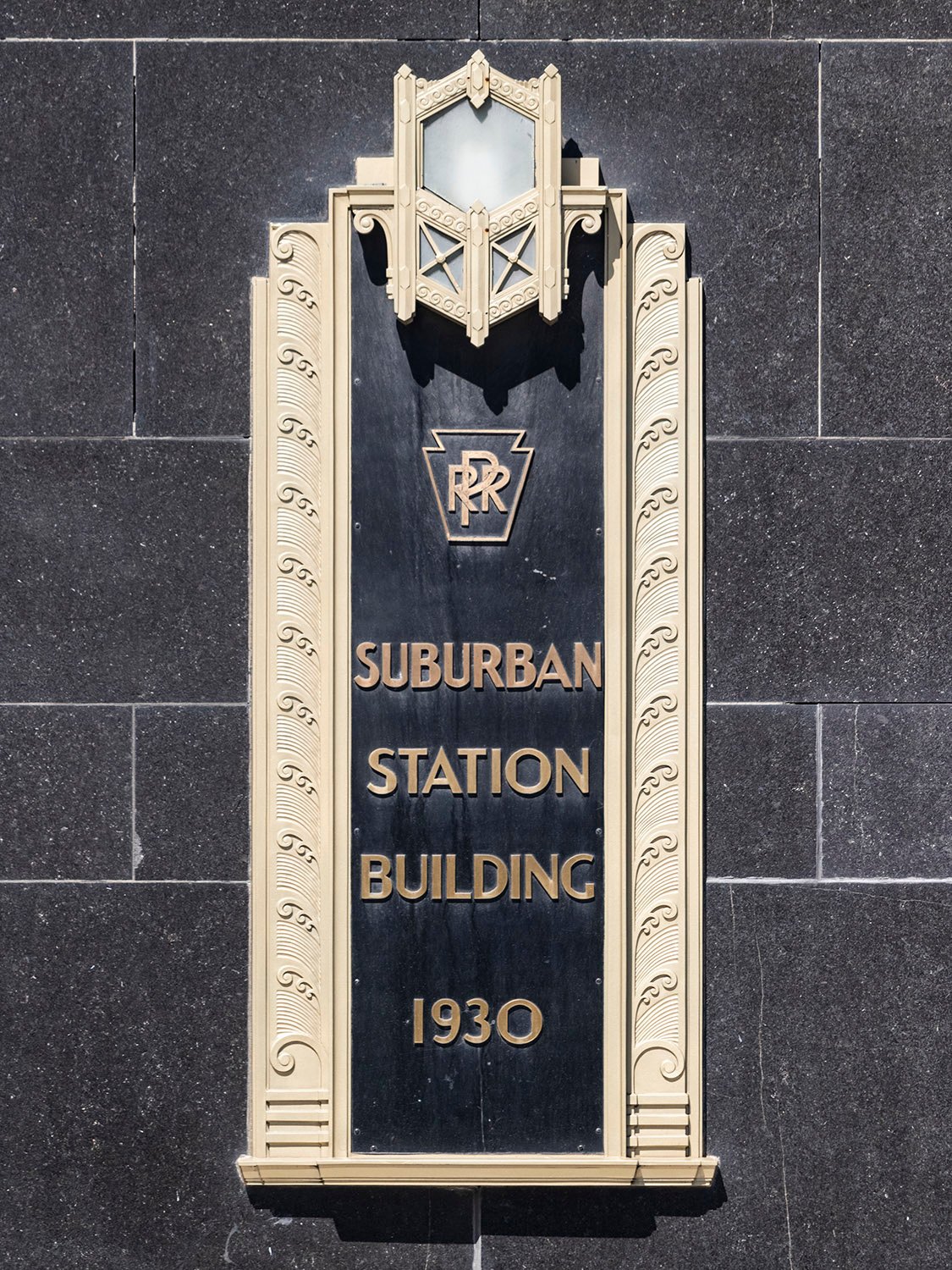 Bronze plaque and light on the facade of Suburban Station, Philadelphia