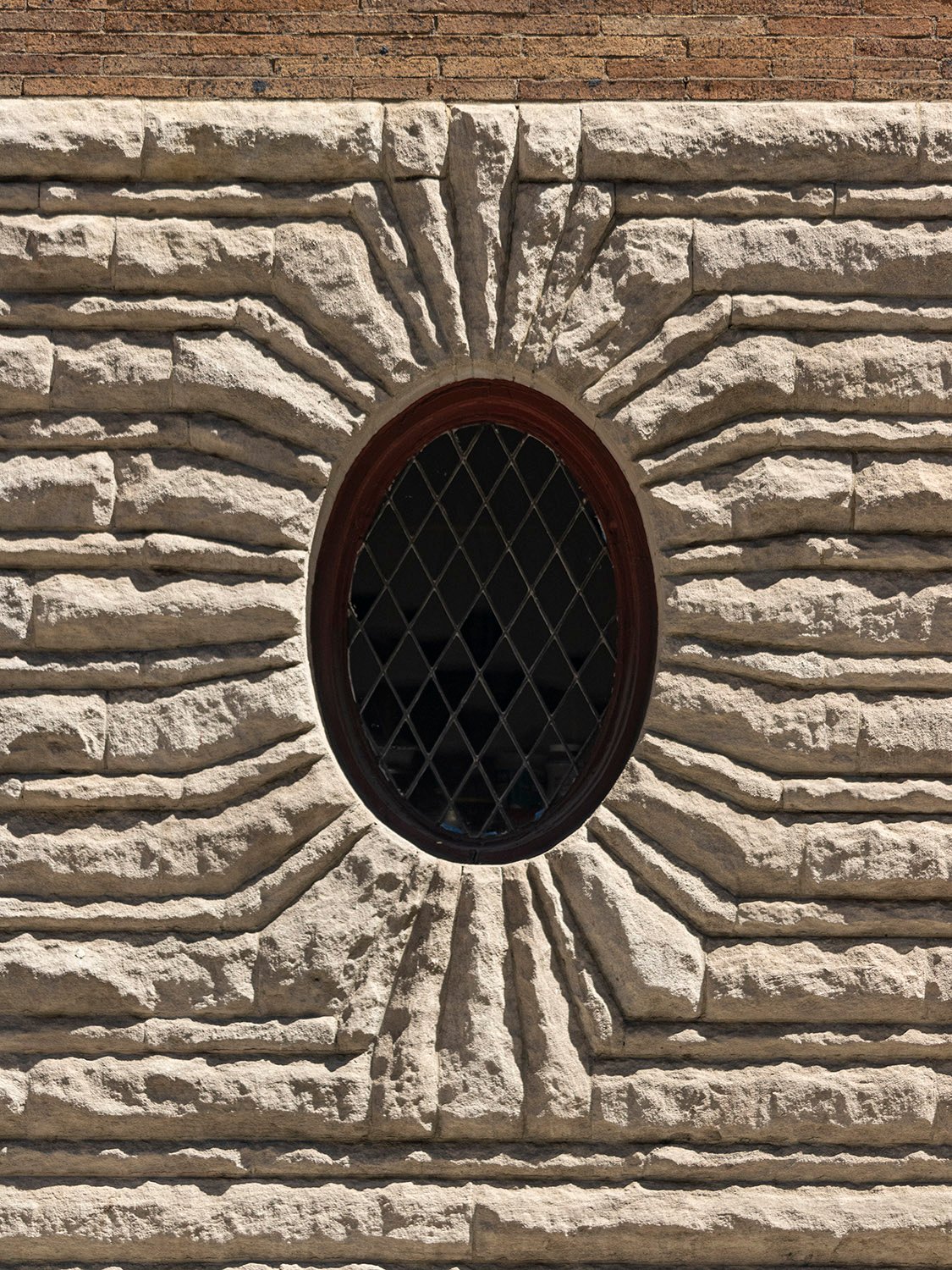Oval window and rusticated limestone on the west elevation of the Clarence B. Moore Residence, Philadelphia