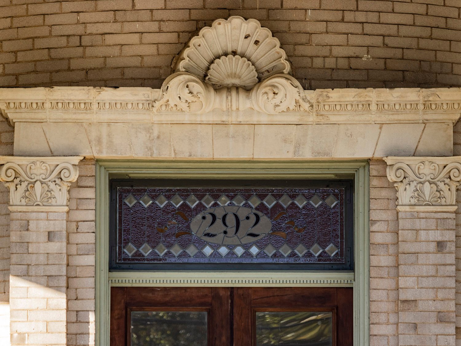 Terracotta pediment and stained-glass transom over the front door of the V.H. Kreigshaber Residence, Atlanta