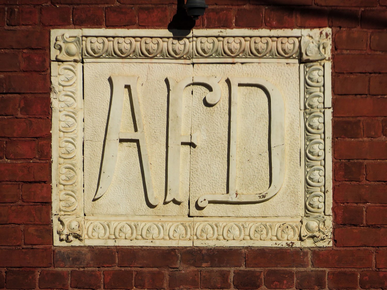 Terracotta Atlanta Fire Department insignia on the facade of Engine House No, 6, Atlanta