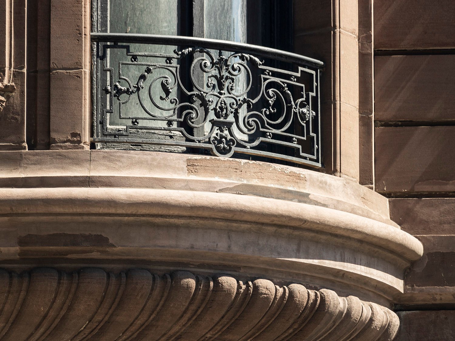 Second-floor window and ribbed brownstone corbel on the Samuel W. Bowne Residence, New York