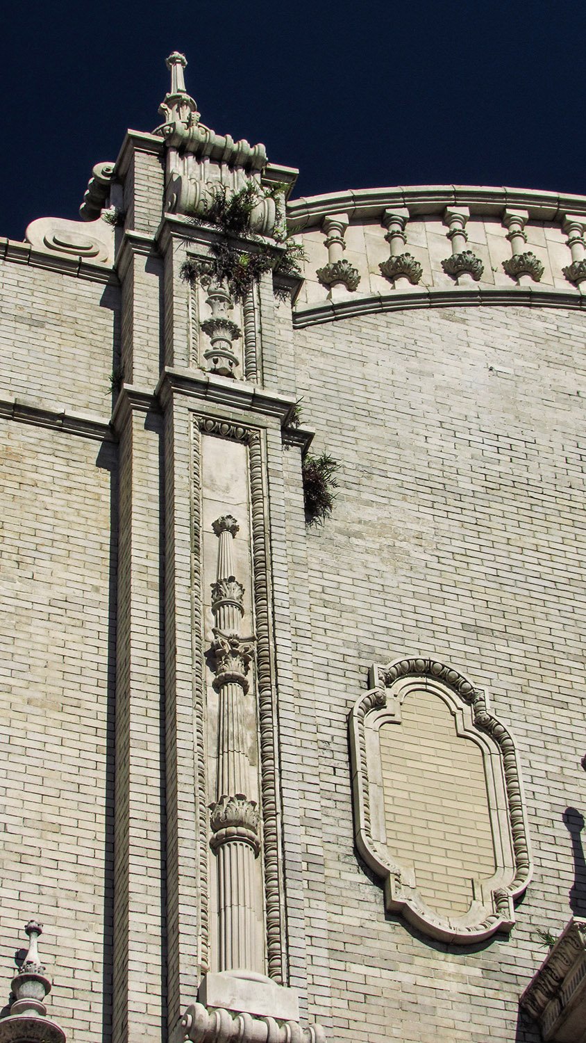 Looking up at a pinnacle and terracotta ornamentation on the facade of the Gulf, Mobile and Ohio Passenger Terminal, Mobile, Alabama